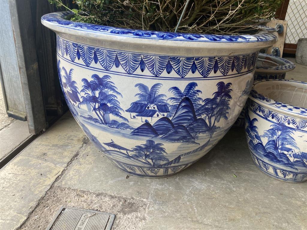 A graduated set of six Chinese style blue and white circular planters, largest width 70cm, height 50cm